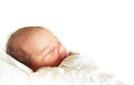 sleeping newborn baby in the hospital - the first hours of the new lifeの写真素材