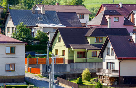 repaired rural house, fixed facade, insulation and painted to green  color, far viewの写真素材