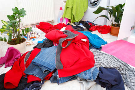 pile of dirty clothes ready for the wash in home bathroom