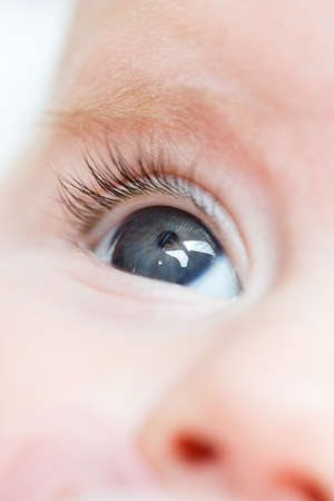 macro of adorable baby girl eye with shallow focusの写真素材