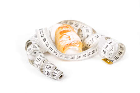 cakes with measuring tape on white background