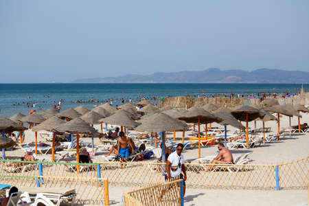 BORJ CEDRIA, TUNISIA - AUGUST 10: People relaxing at hotel beach. Club Caribbean also offers, large outdoor pool, excellent entertainment team and children?s club. August 10, 2014 Borj Cedria, Tunisia.のeditorial素材