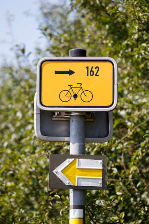 Starting point for cyclists on metal poles in the rural landscape