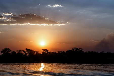 African sunset on Chobe river, Chobe National Park, Botswanaの写真素材