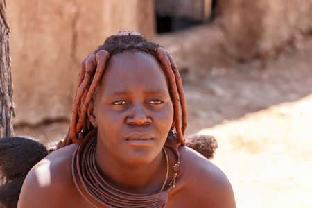 NAMIBIA, KAMANJAB, OCTOBER 10: Himba tribe woman with ornaments on the neck, in the village of Himba people near Kamanjab in northern Namibia, August 10, 2014, Namibiaのeditorial素材