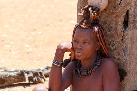 NAMIBIA, KAMANJAB, OCTOBER 10: Himba tribe woman with ornaments on the neck, in the village of Himba...