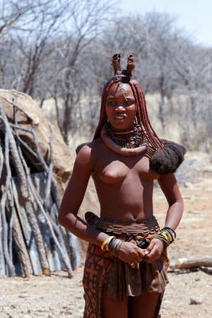 NAMIBIA, KAMANJAB, OCTOBER 10: Himba tribe woman with ornaments on the neck, in the village of Himba people near Kamanjab in northern Namibia, August 10, 2014, Namibiaのeditorial素材