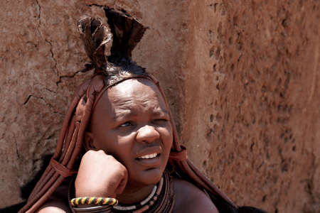 NAMIBIA, KAMANJAB, OCTOBER 10: Himba tribe woman with ornaments on the neck, in the village of Himba...