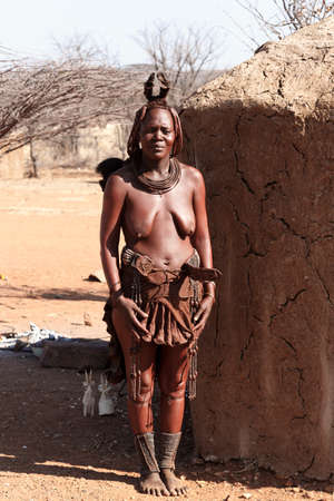 NAMIBIA, KAMANJAB, OCTOBER 10: Himba tribe woman with ornaments on the neck, in the village of Himba...