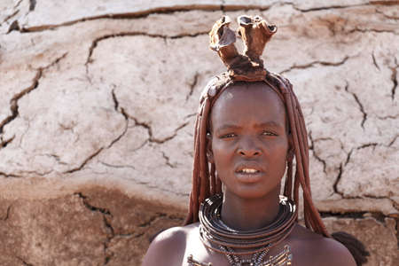 NAMIBIA, KAMANJAB, OCTOBER 10: Himba tribe woman with ornaments on the neck, in the village of Himba people near Kamanjab in northern Namibia, October 10, 2014, Namibiaのeditorial素材