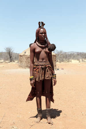 NAMIBIA, KAMANJAB, OCTOBER 10: Himba tribe woman with ornaments on the neck, in the village of Himba people near Kamanjab in northern Namibia, October 10, 2014, Namibiaのeditorial素材