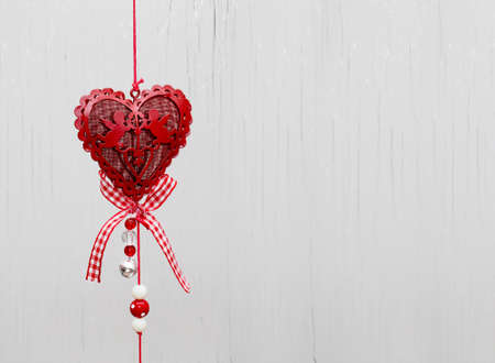Heart as a symbol of love hanged on cord background/valentine day backgroundの写真素材