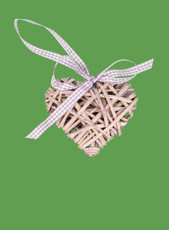 valentine's wooden hearts isolated on green background, valentine postcard with space for textの写真素材