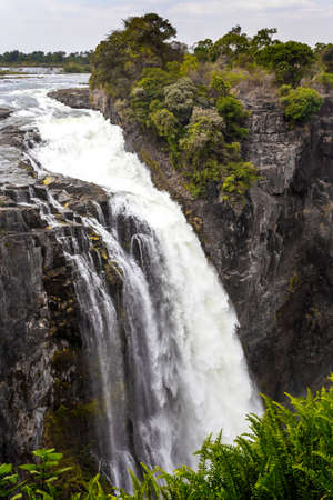 The Victoria falls is the largest curtain of water in the world (1708 meters wide). The falls and the surrounding area is the National Parks and World Heritage Site - Zambia, Zimbabweの写真素材