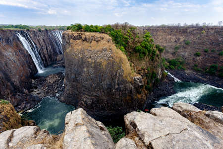 The Victoria falls is the largest curtain of water in the world (1708 meters wide). The falls and the surrounding area is the National Parksの写真素材