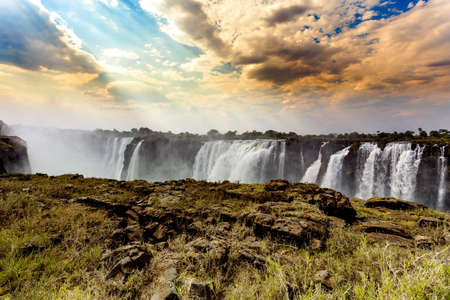 The Victoria falls is the largest curtain of water in the world (1708 meters wide). The falls and the surrounding area is the National Parks の写真素材