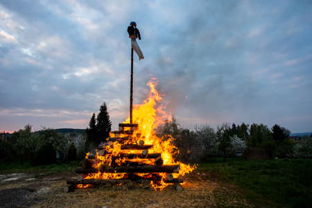 walpurgis night burning witch on wood and religion cross with huge flamesの写真素材