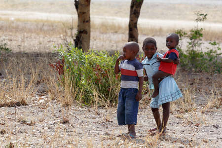 NAMIBIA, KAVANGO, OCTOBER 15: An unidentified dirty and poor Namibiann childrens near town Rundu in Kavango region, with the highest poverty level in Namibia. October 15, 2014, Namibiaのeditorial素材