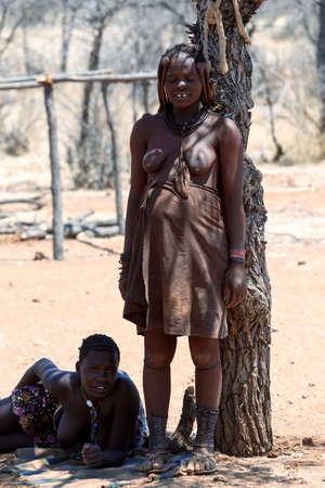 NAMIBIA, KAMANJAB, OCTOBER 10: Himba tribe womans with ornaments on the neck, in the village of...