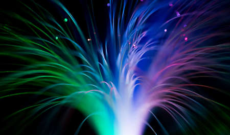 bunch of optical fibres flying from deep as blurred abstract technology backgroundの写真素材