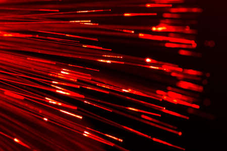 bunch of optical fibres flying from deep as blurred abstract technology backgroundの写真素材