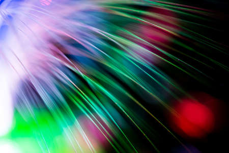 bunch of optical fibres flying from deep as blurred abstract technology backgroundの写真素材