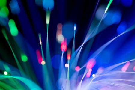 bunch of optical fibres flying from deep as blurred abstract technology backgroundの写真素材