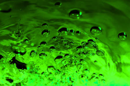 green abstract background with water drops on glass for background or backdropの写真素材
