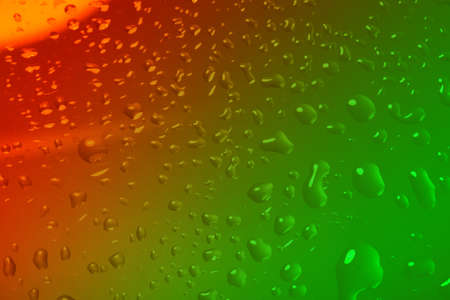 color abstract background with water drops on glass for background or backdropの写真素材