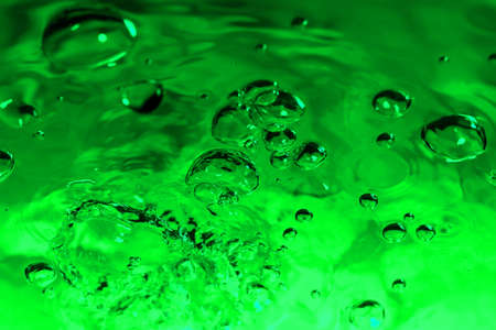green abstract background with water drops on glass for background or backdropの写真素材
