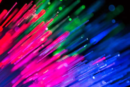 bunch of optical fibres flying from deep as blurred abstract technology backgroundの写真素材