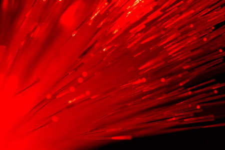 bunch of optical fibres flying from deep as blurred abstract technology backgroundの写真素材