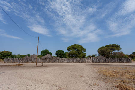 Traditional african village with housed and wooden fence in Namibia, near town Kavango in region with the highest poverty level in Namibiaの写真素材