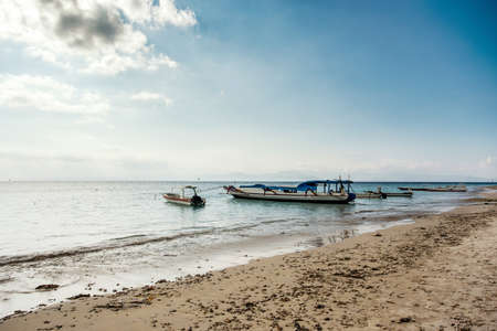 dream sand beach with boat, Bali Indonesia, Nusa Penida island with dramatic blue sky