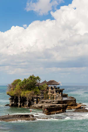 famous Tanah Lot Temple on Sea in Bali Island Indonesia with blue sky and wavesの写真素材