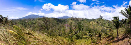 panorama of traditional Indonesian landscape with volcano and palms, Sulawesi, Manado, indonesiaの写真素材