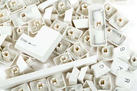 pile of scattered white keyboard keys on white backgroundの写真素材