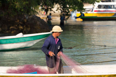 PENIDA ISLAND, INDONESIA - JUNE 29.2015: Hindu fisherman men preparing net for fishing, village Toyapakeh, Nusa Penida, Bali June 29. 2015 Indonesiaのeditorial素材