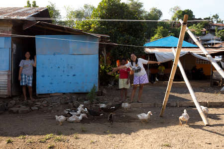 MANADO, NORTH SULAWESI, INDONESIA - AUGUST 5, 2015: Happy indonesian womans in Manado shantytown on August 5, 2015 in Manado, North Sulawesi, Indonesiaのeditorial素材