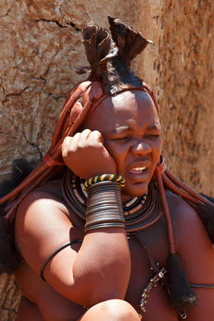 NAMIBIA, KAMANJAB, OCTOBER 10: Himba tribe woman with ornaments on the neck, in the village of Himba...