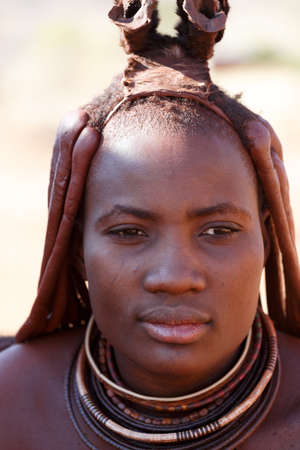 NAMIBIA, KAMANJAB, OCTOBER 10: Himba tribe woman with ornaments on the neck, in the village of Himba...