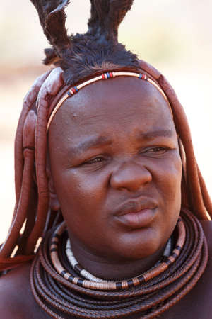 NAMIBIA, KAMANJAB, OCTOBER 10: Himba tribe woman with ornaments on the neck, in the village of Himba...
