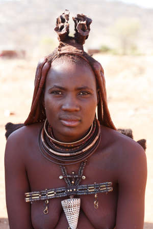 NAMIBIA, KAMANJAB, OCTOBER 10: Himba tribe woman with ornaments on the neck, in the village of Himba people near Kamanjab in northern Namibia, October 10, 2014, Namibiaのeditorial素材