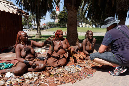 NAMIBIA, SWAKOPMUND, OCTOBER 8: Group of Himba girl with souvenirs for sale in the main marketplace in Svakopmund in northern Namibia, October 8, 2014, Namibiaのeditorial素材