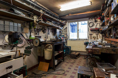 real dirty domestic DIY home workshop full of tools, untidy, ready for work