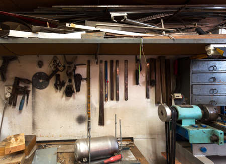 real dirty domestic DIY home workshop full of tools, untidy, ready for workの写真素材