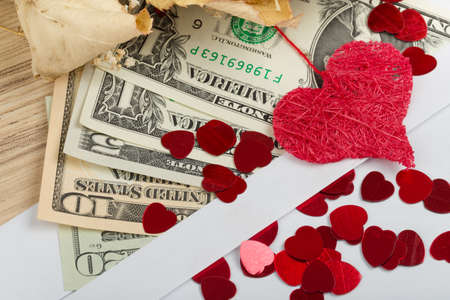 valentine concept with hearts, dry roses and us dollar banknotes as valentine presentの写真素材