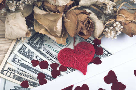 valentine concept with hearts, dry roses and us dollar banknotes as valentine present, retro color toneの写真素材