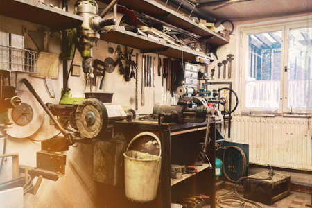 real domestic DIY home workshop full of tools, untidy, ready for work, detail of homemade lathe,...