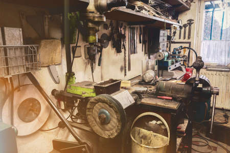real domestic DIY home workshop full of tools, untidy, ready for work, detail of homemade lathe,...